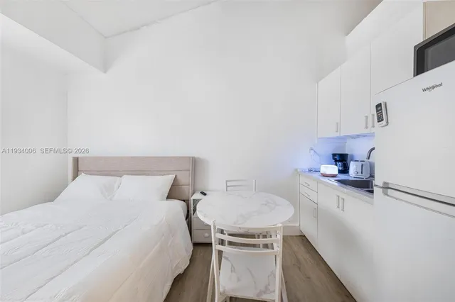 a bedroom with a bed and a table in it