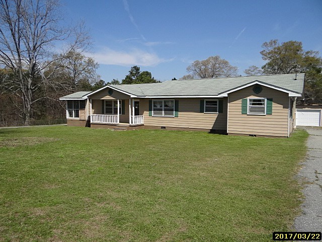 2 Moore Road Fort Mitchell, AL 36856 - Photo 1 of 16 a front view of a house with a garden