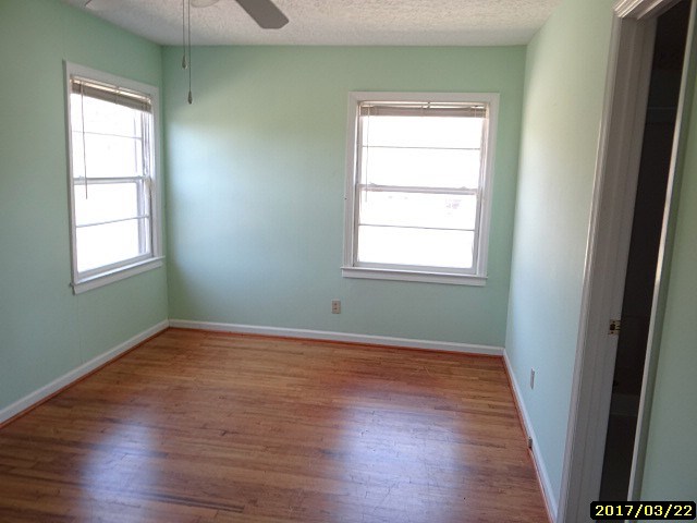2 Moore Road Fort Mitchell, AL 36856 - Photo 5 of 16 an empty room with wooden floor and windows