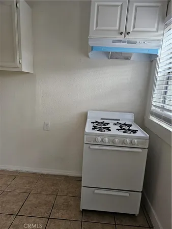 a kitchen with white cabinets