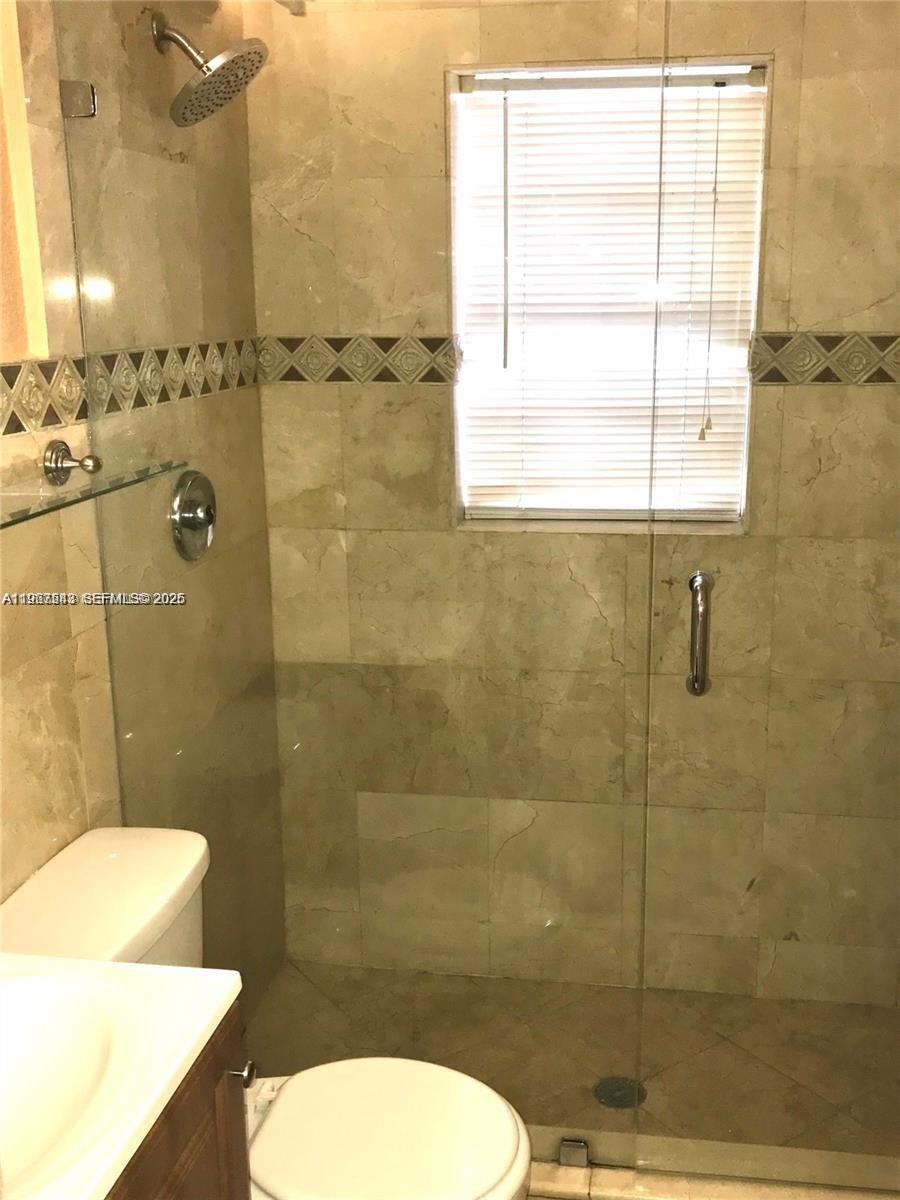 27 Southwest 55th Avenue Road Miami, FL 33134 - Photo 13 of 17 a bathroom with a toilet sink and shower