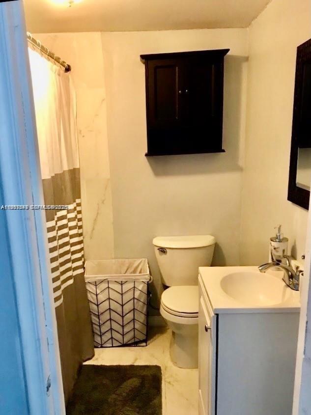 27 Southwest 55th Avenue Road Miami, FL 33134 - Photo 8 of 17 a bathroom with a sink and a mirror