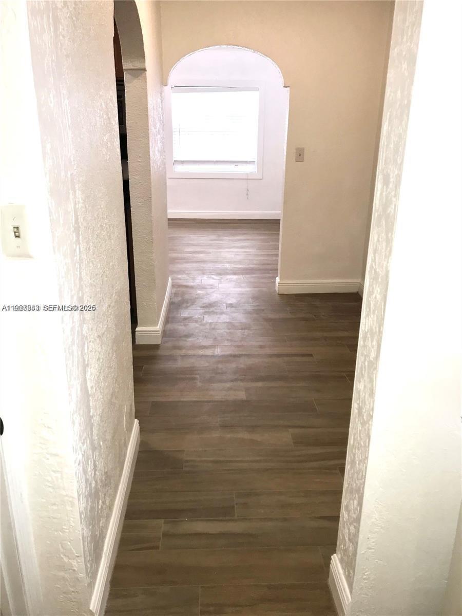 27 Southwest 55th Avenue Road Miami, FL 33134 - Photo 10 of 17 a view of a hallway with wooden floor and staircase