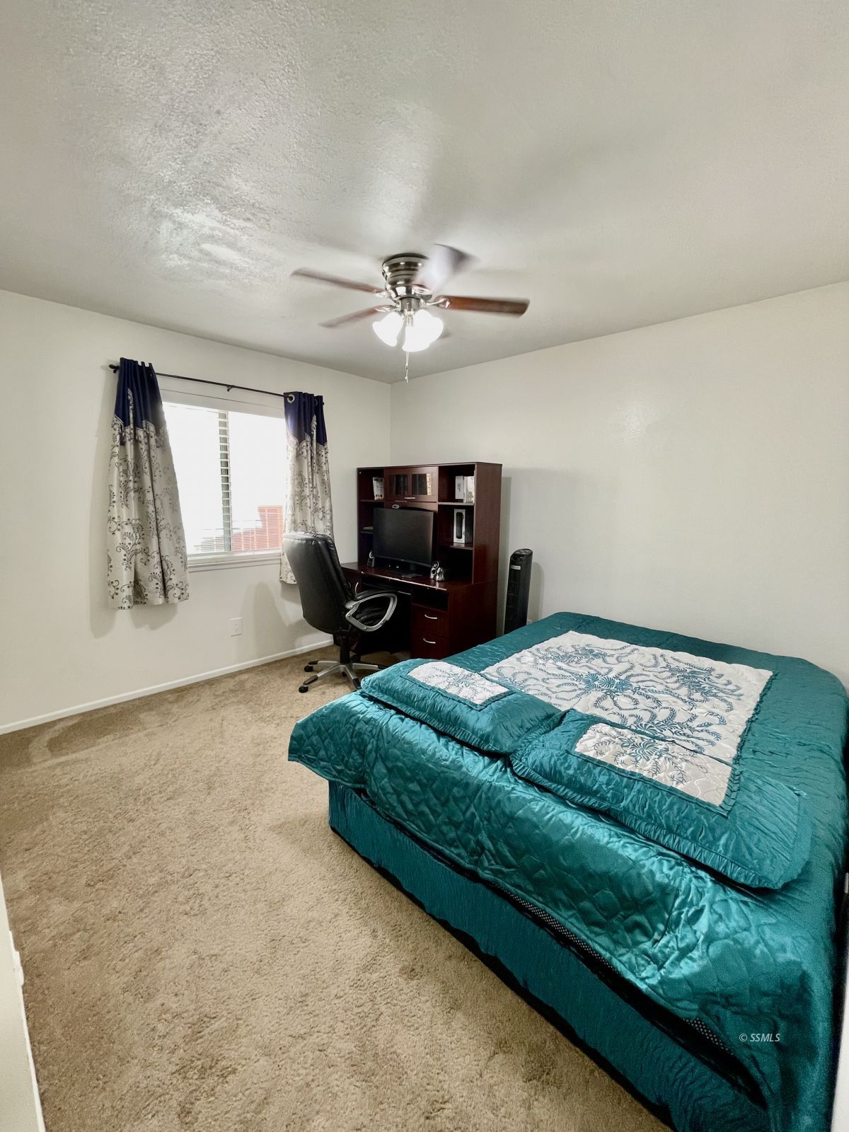 233 West St George Avenue Ridgecrest, CA 93555 - Photo 9 of 47 a bedroom with a bed window and a flat screen tv