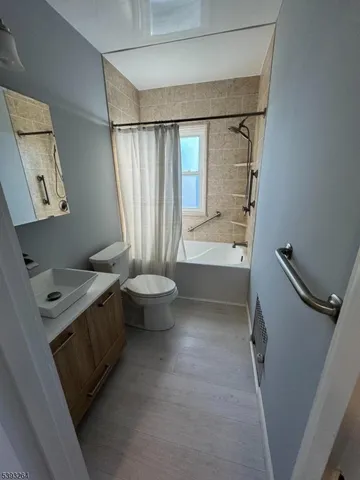 a bathroom with a sink a toilet and tub