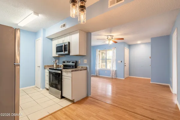 a kitchen with stainless steel appliances granite countertop a refrigerator sink and cabinets