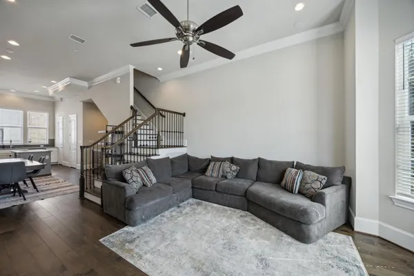 a living room with furniture and wooden floor