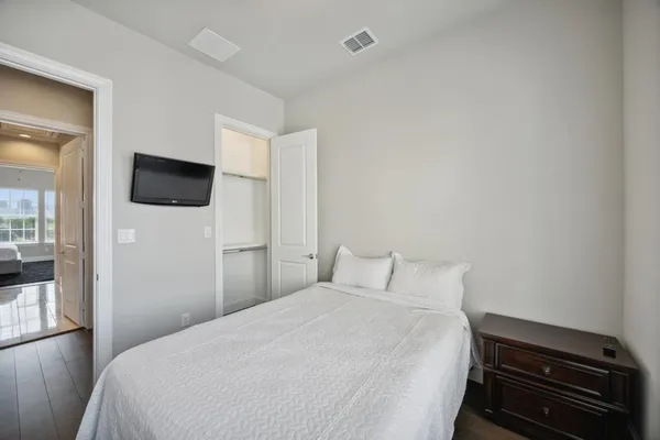 a bedroom with a bed and a flat screen tv