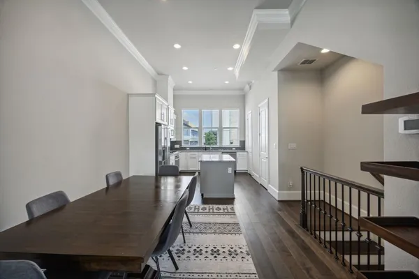a dining room with furniture and wooden floor
