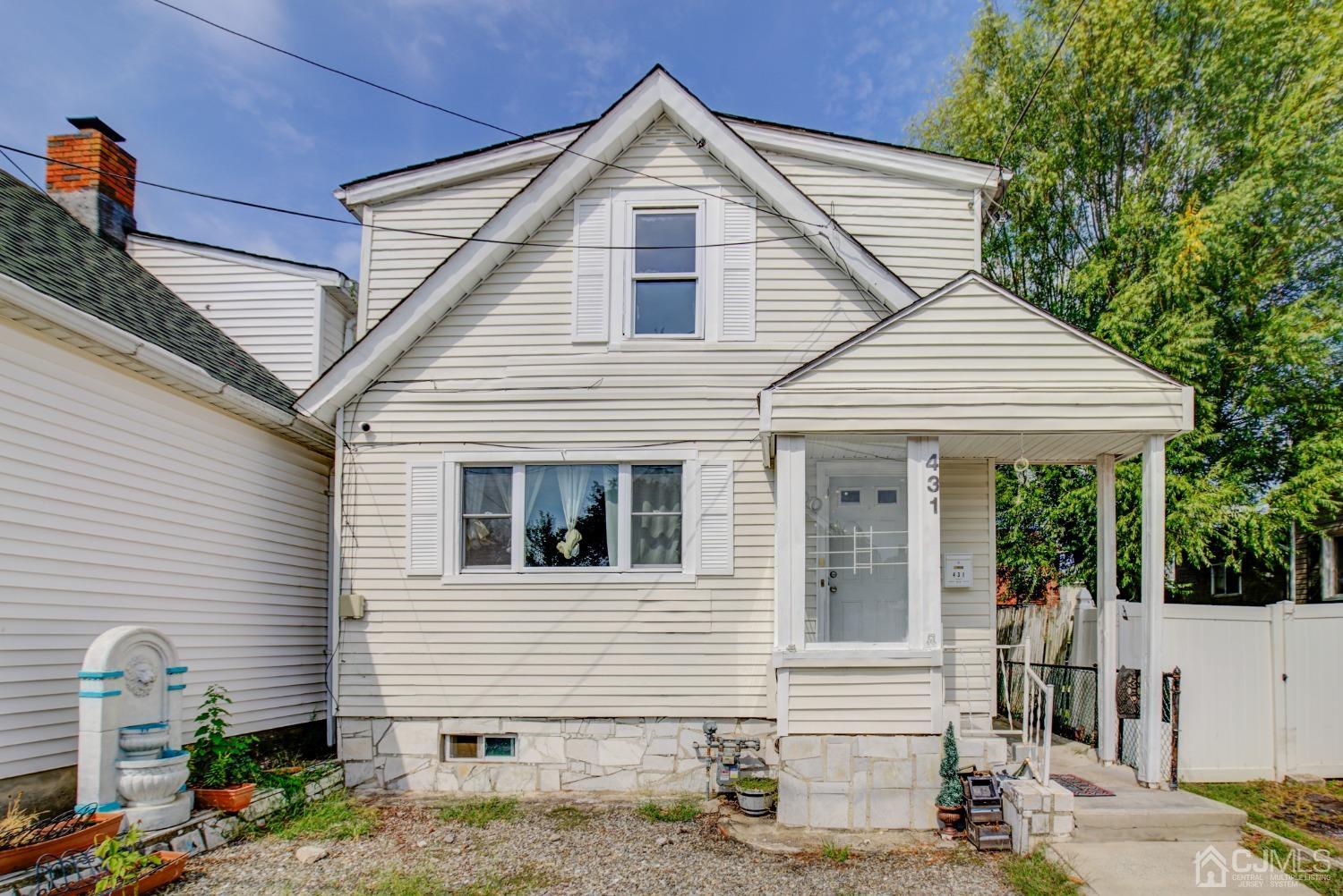 431 Baker Place Perth Amboy, NJ 08861 - Photo 1 of 16 a front view of a house with a yard