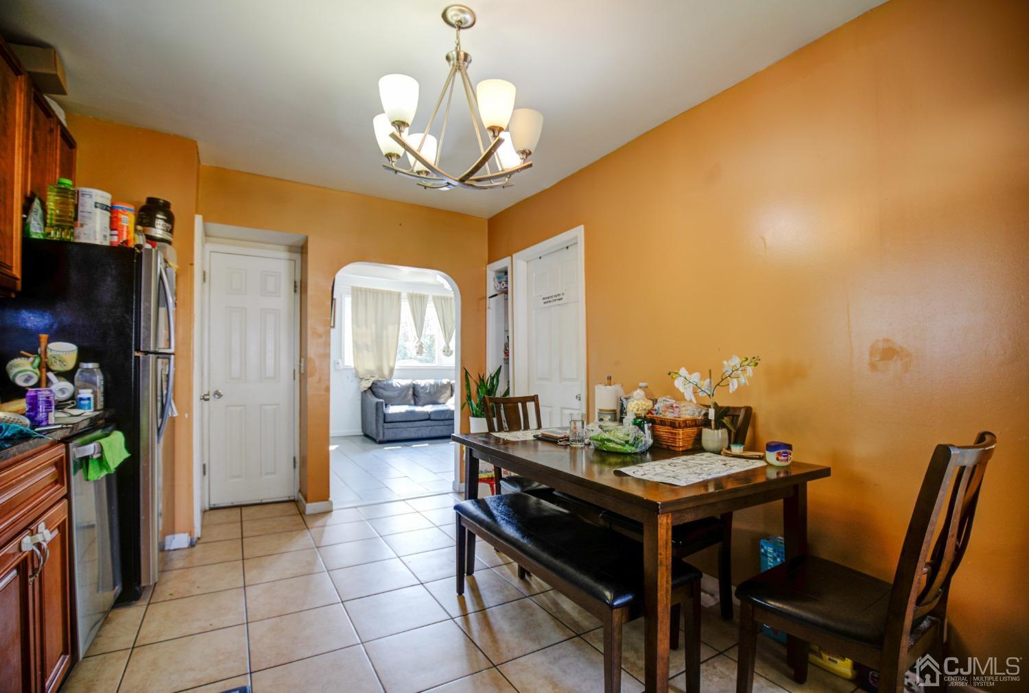 431 Baker Place Perth Amboy, NJ 08861 - Photo 11 of 16 a view of a dining room with furniture and a chandelier