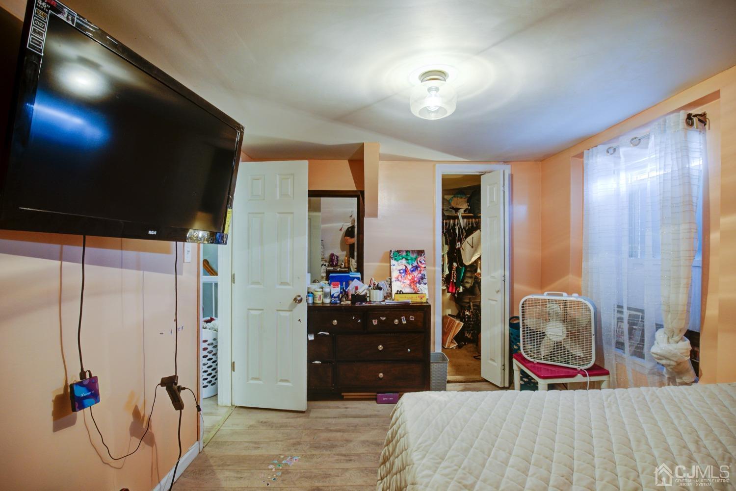 431 Baker Place Perth Amboy, NJ 08861 - Photo 12 of 16 a bedroom with a bed and a large mirror