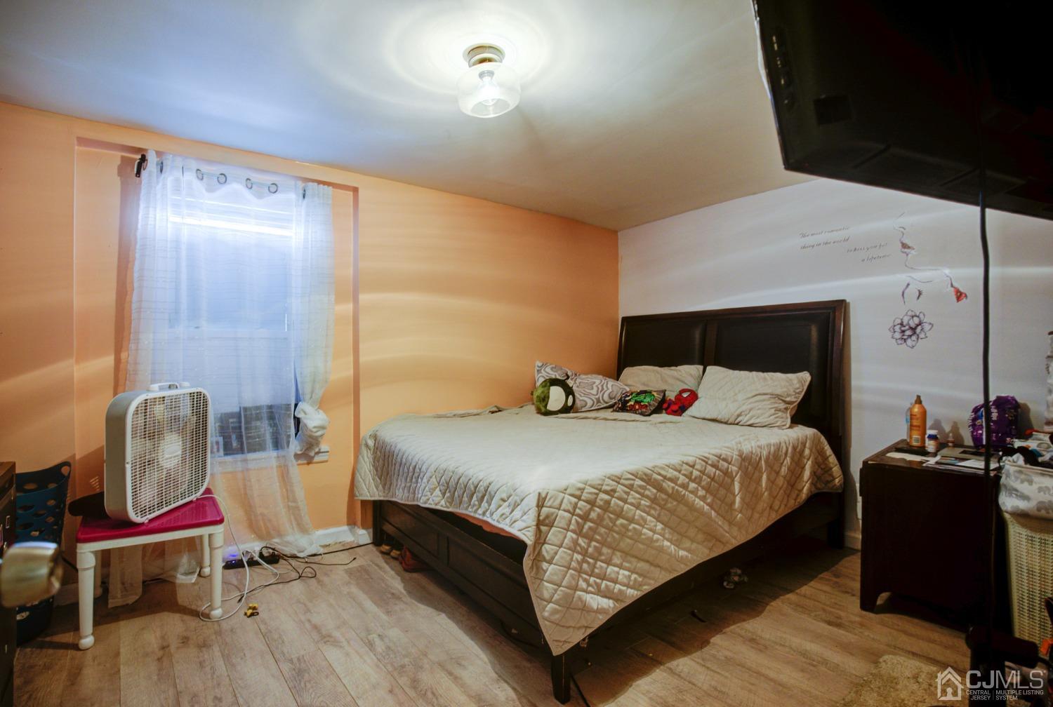 431 Baker Place Perth Amboy, NJ 08861 - Photo 13 of 16 a bedroom with a bed and a mirror