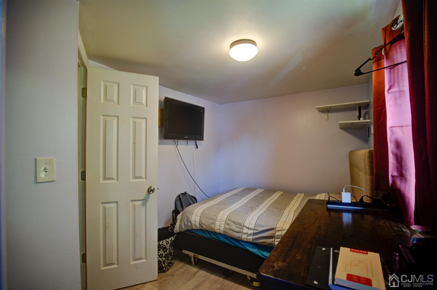 431 Baker Place Perth Amboy, NJ 08861 - Photo 16 of 16 a bedroom with a bed and a flat screen tv
