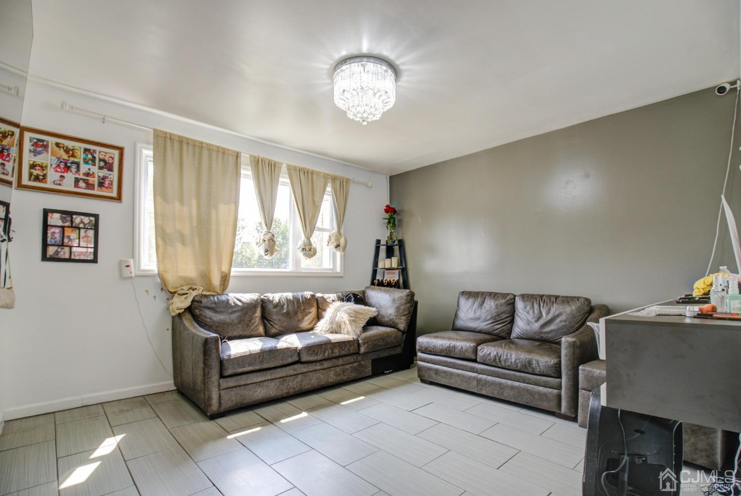 431 Baker Place Perth Amboy, NJ 08861 - Photo 5 of 16 a living room with furniture and a large window