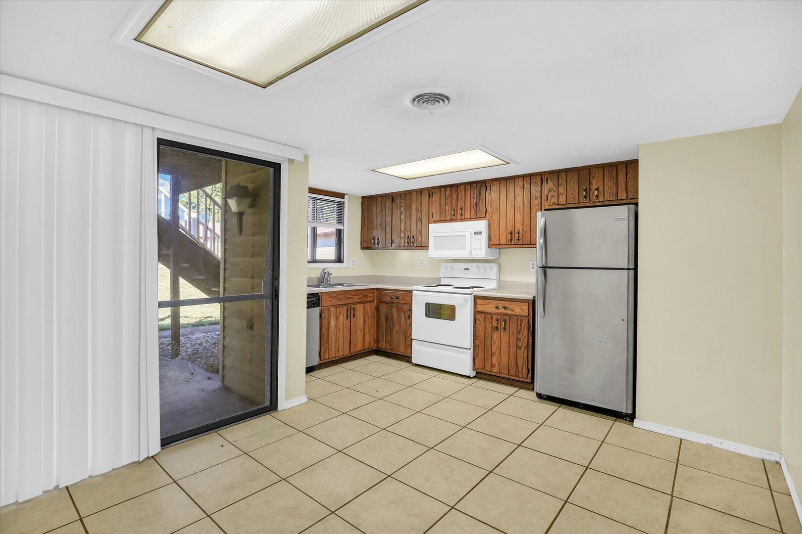 1905 Christopher Circle, Unit 4 Urbana, IL 61802 - Photo 12 of 29 a kitchen with a refrigerator a sink and cabinets
