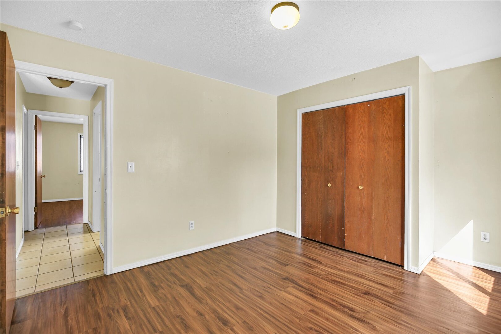1905 Christopher Circle, Unit 4 Urbana, IL 61802 - Photo 20 of 29 an empty room with wooden floor and windows
