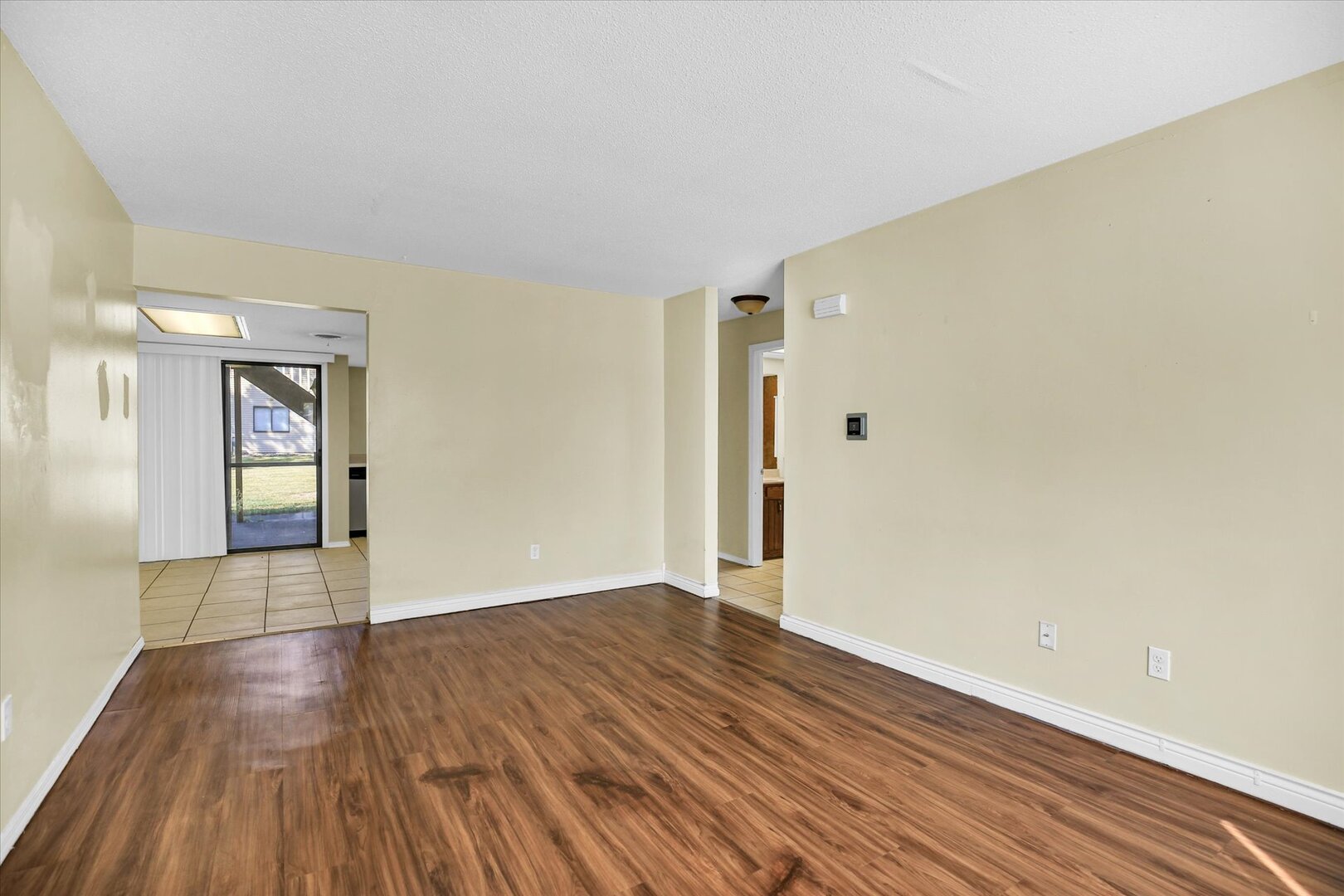 1905 Christopher Circle, Unit 4 Urbana, IL 61802 - Photo 10 of 29 wooden floor in an empty room with a window