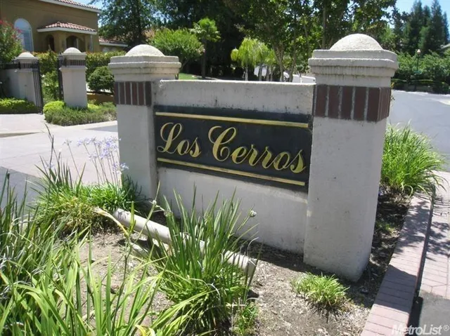 a view of sign board with potted plants