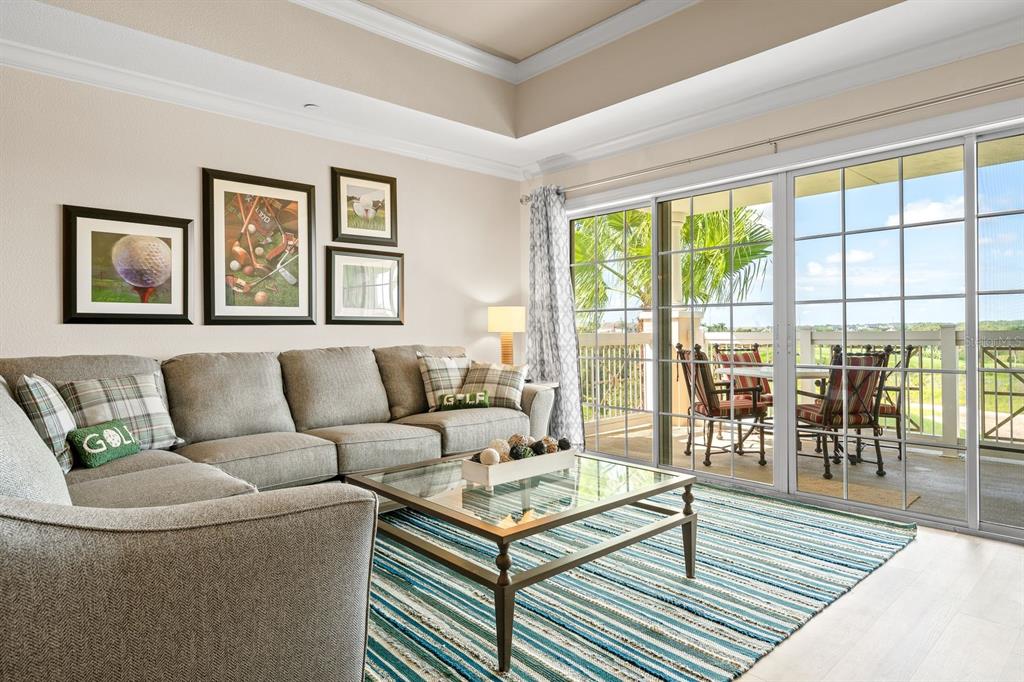 1370 Centre Ct Ridge Drive, Unit 401 Reunion, FL 34747 - Photo 15 of 51 a living room with furniture and a floor to ceiling window