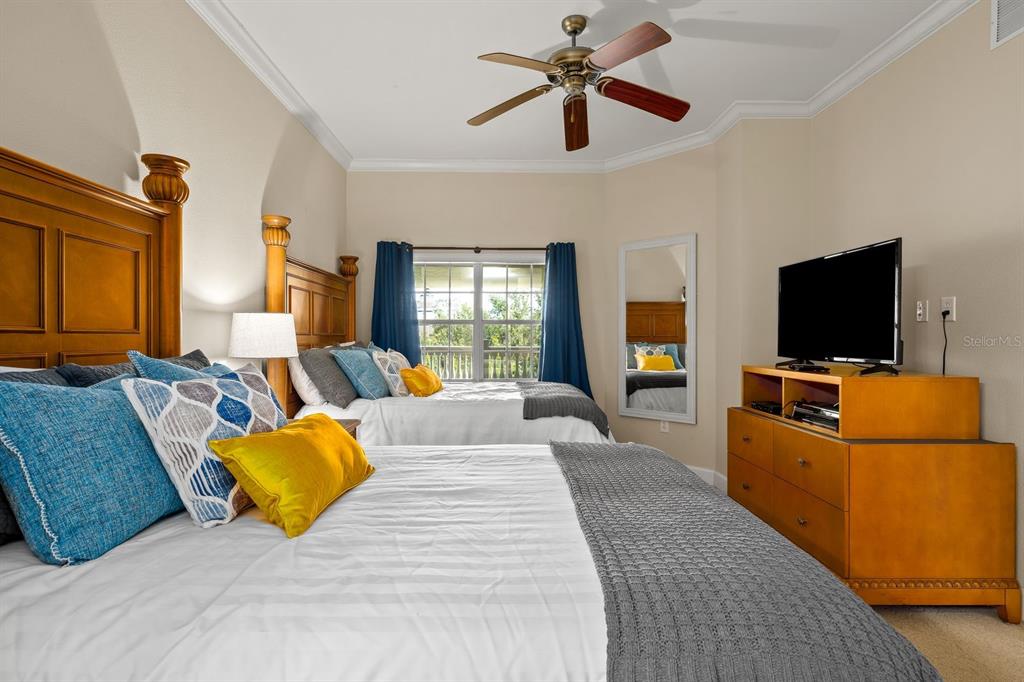 1370 Centre Ct Ridge Drive, Unit 401 Reunion, FL 34747 - Photo 22 of 51 a living room with furniture and a flat screen tv