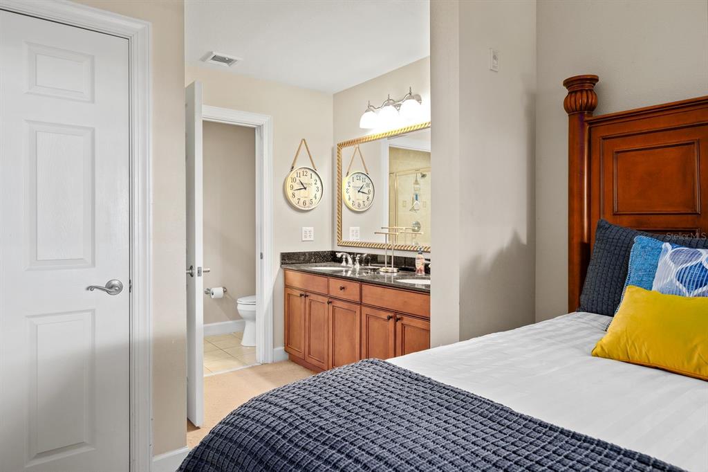 1370 Centre Ct Ridge Drive, Unit 401 Reunion, FL 34747 - Photo 24 of 51 a bedroom with a bed and a cabinets