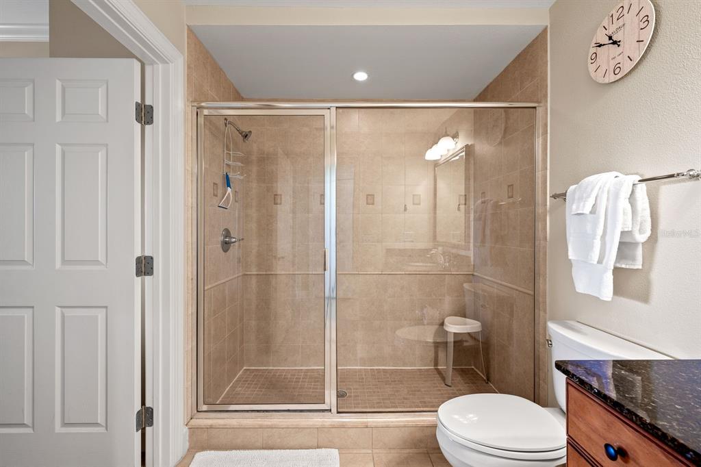 1370 Centre Ct Ridge Drive, Unit 401 Reunion, FL 34747 - Photo 30 of 51 a bathroom with a shower a toilet and a sink