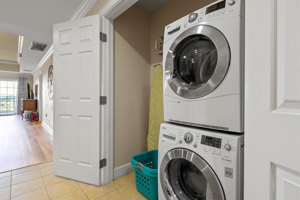 1370 Centre Ct Ridge Drive, Unit 401 Reunion, FL 34747 - Photo 31 of 51 a view of a hallway with washer and dryer