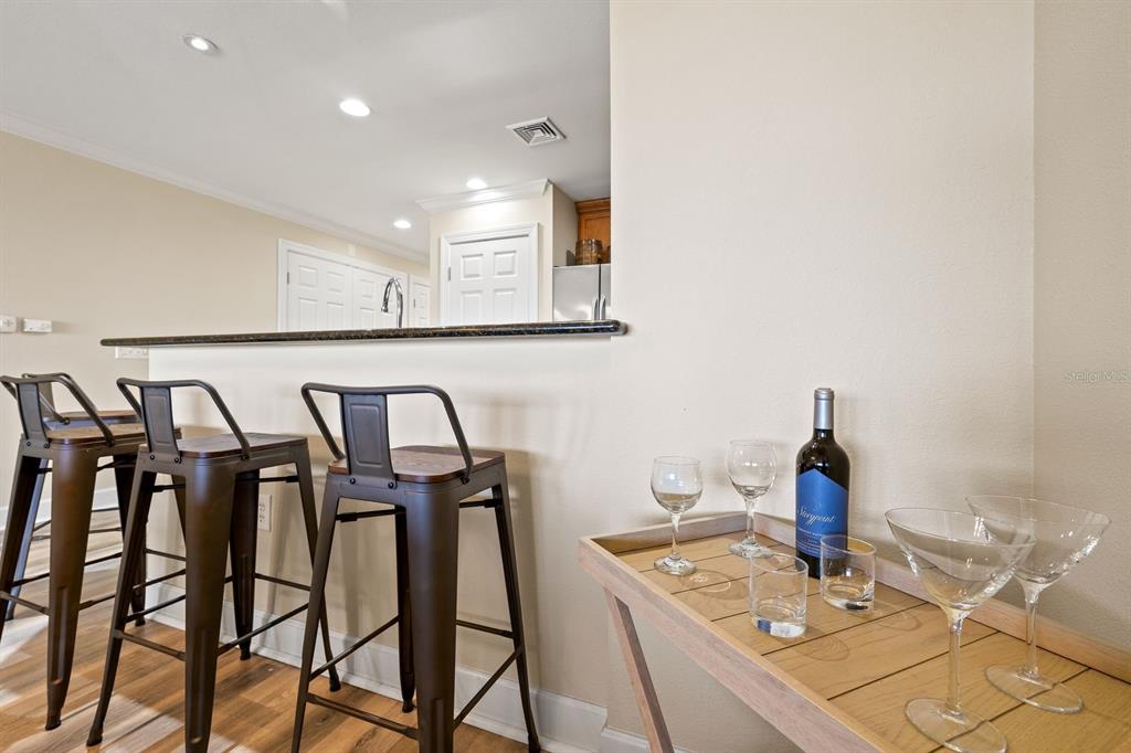 1370 Centre Ct Ridge Drive, Unit 401 Reunion, FL 34747 - Photo 10 of 51 a view of a kitchen with a table and chairs
