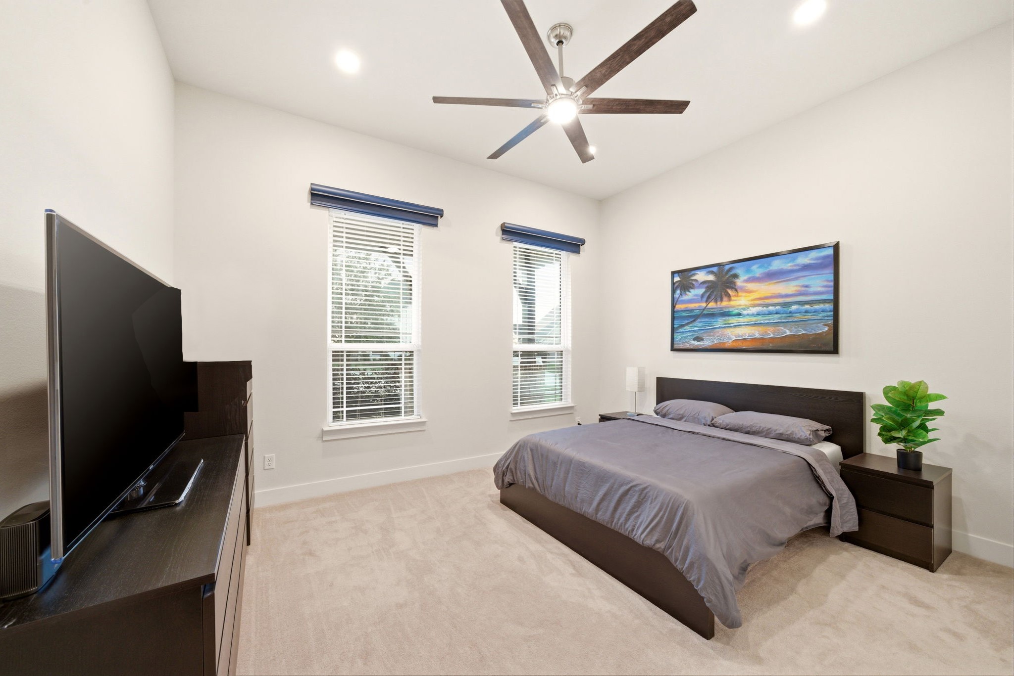 28811 Ember Crest Lane Fulshear, TX 77441 - Photo 10 of 47 a bedroom with a bed a dresser and a flat screen tv