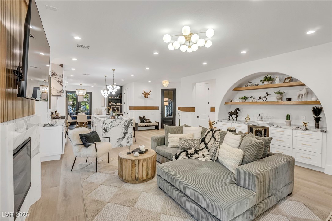 2709 Rue Toulouse Avenue Henderson, NV 89044 - Photo 11 of 43 Living Room with Wood-Like Tile/Fireplace and TV