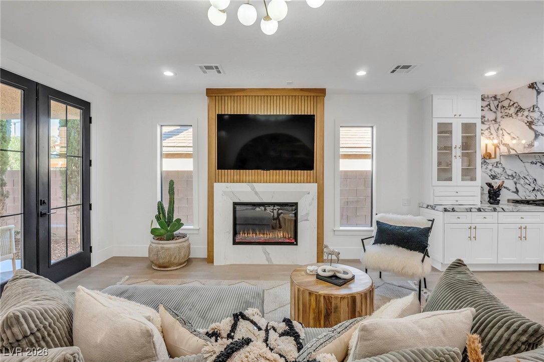 2709 Rue Toulouse Avenue Henderson, NV 89044 - Photo 10 of 43 Living Room with Custom Fireplace and French Doors to Backyard Patio