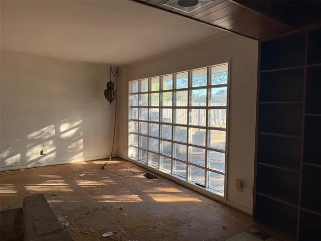 a view of an empty room with a window