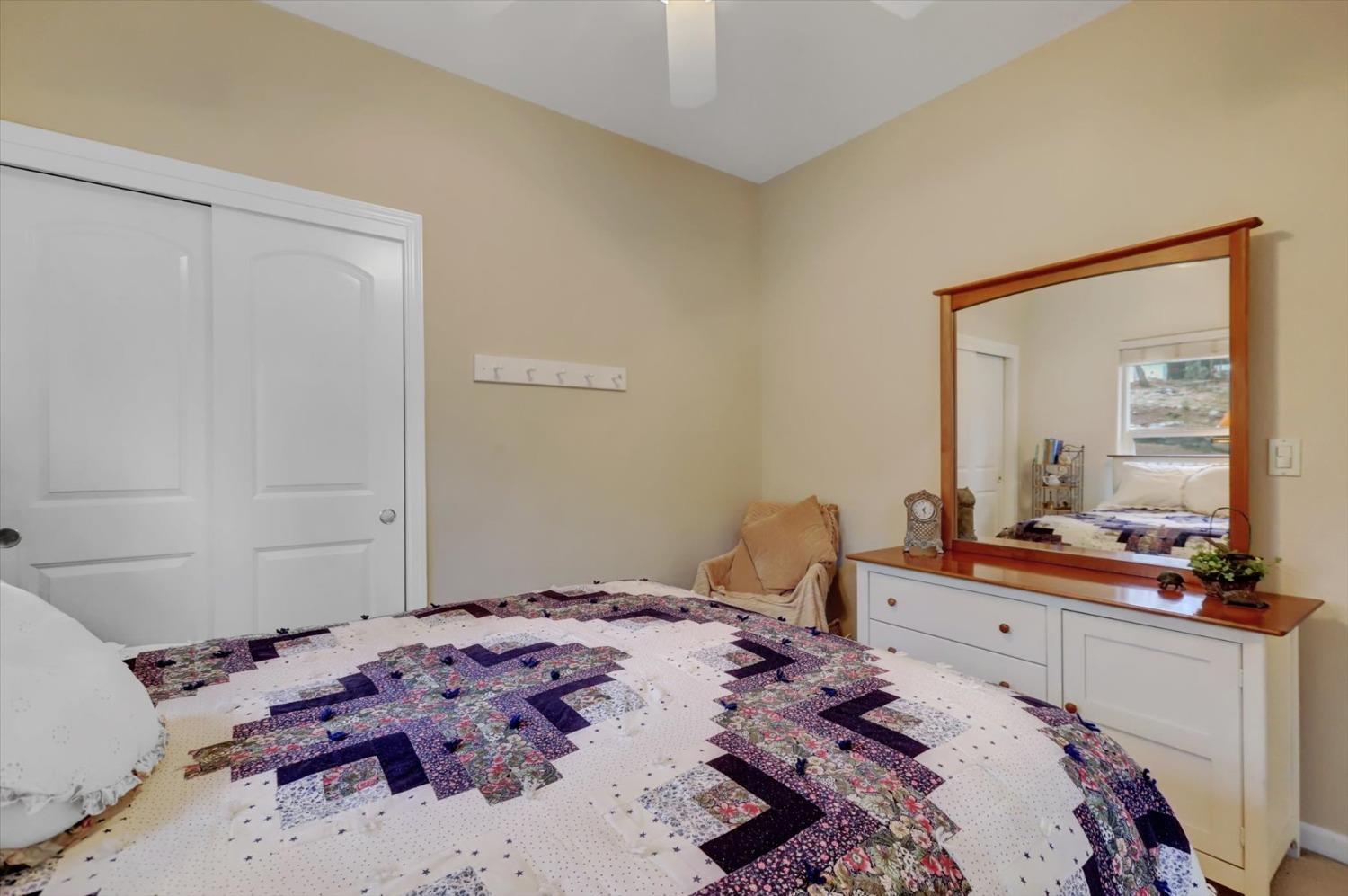 17036 Alice Way Grass Valley, CA 95949 - Photo 29 of 58 a bedroom with a bed and a mirror