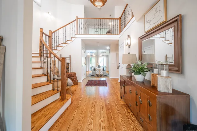 a view of a hallway with wooden floor and staircase