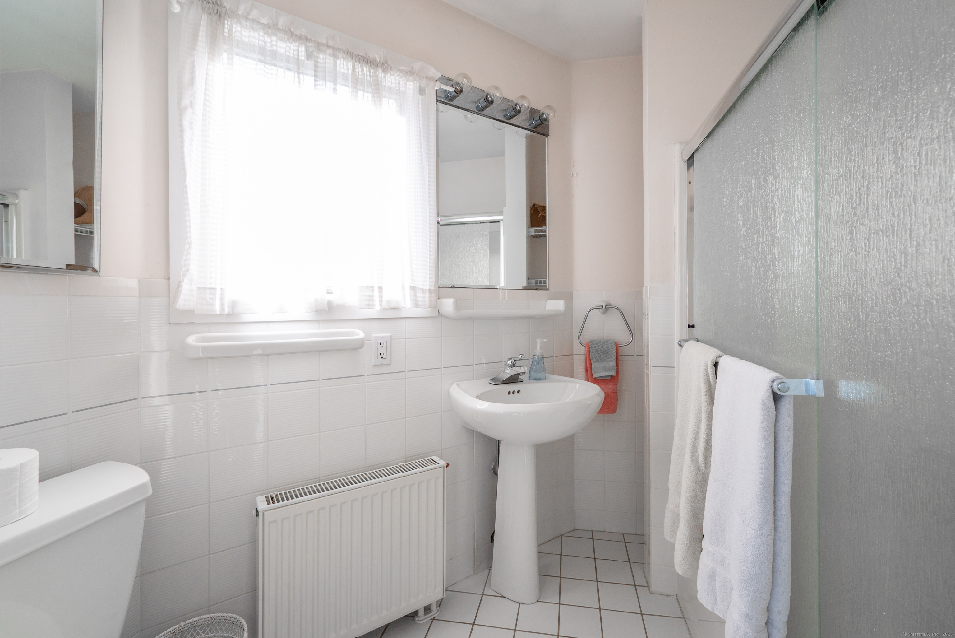 20 Shore Road Danbury, CT 06811 - Photo 15 of 40 a bathroom with a sink a toilet and a mirror