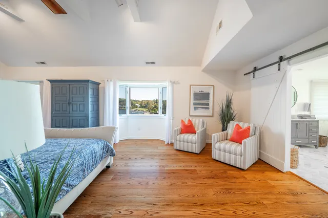 a spacious bedroom with a bed and a couch