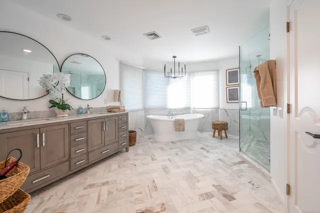 a spacious bathroom with a double vanity sink and a mirror