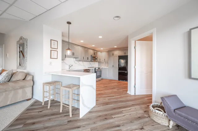 a kitchen with stainless steel appliances kitchen island granite countertop a refrigerator and a stove top oven