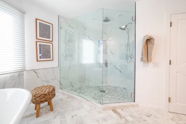 a bathroom with a bath tub and shower
