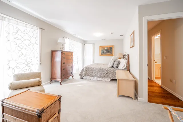 a bedroom with furniture and a large mirror