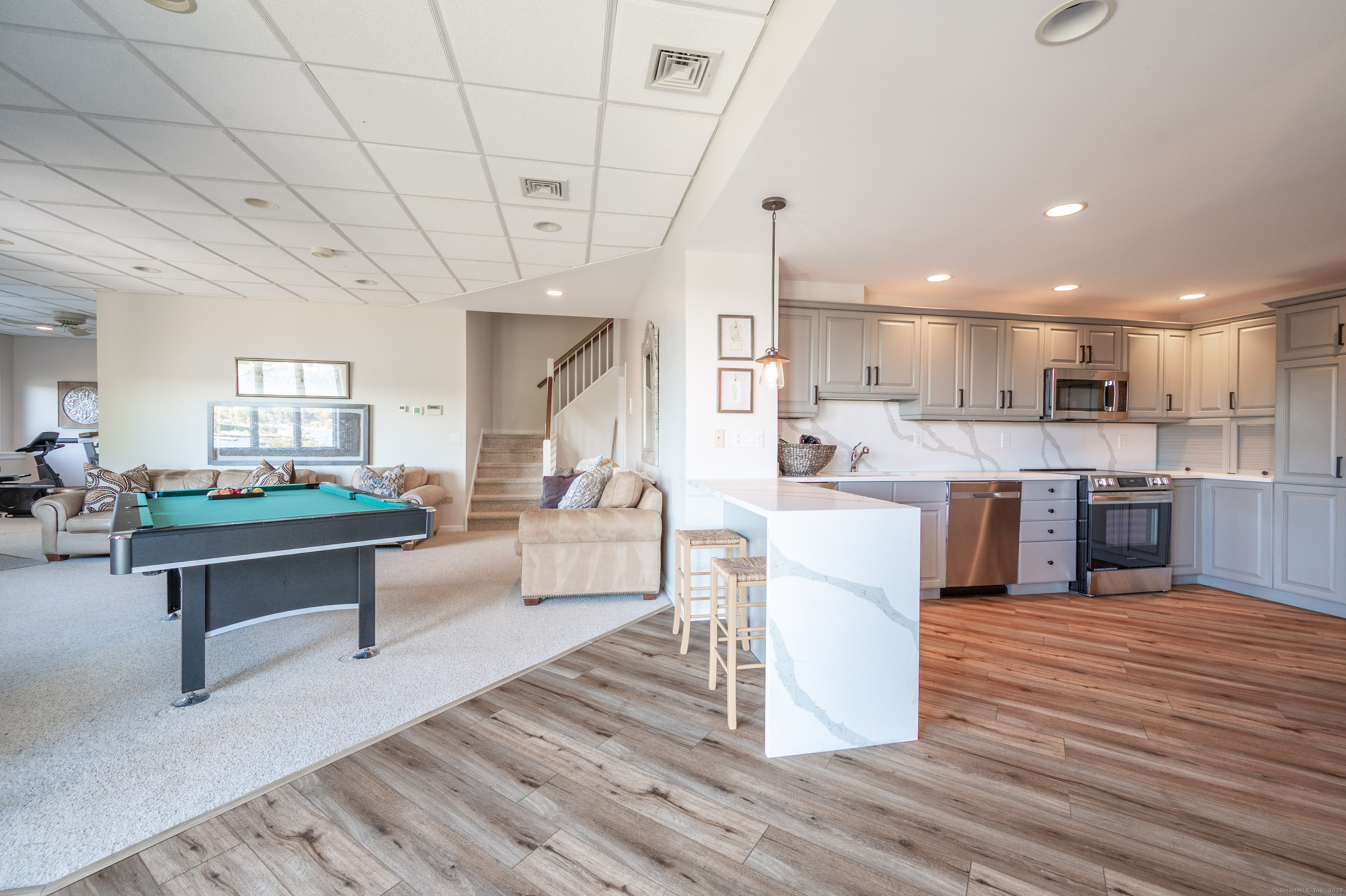 20 Shore Road Danbury, CT 06811 - Photo 29 of 40 a living room with kitchen island furniture and a kitchen view