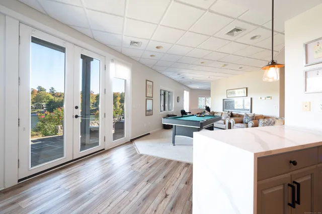 a living room with furniture a flat screen tv and a large window
