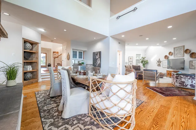 a living room with lots of furniture and kitchen view