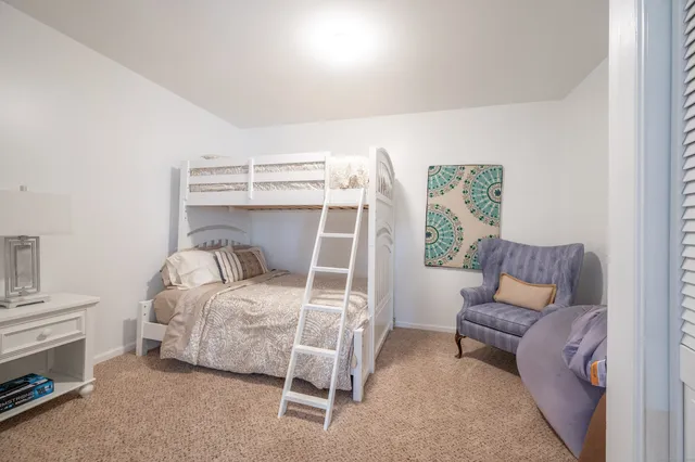 a bedroom with a bed and a chair