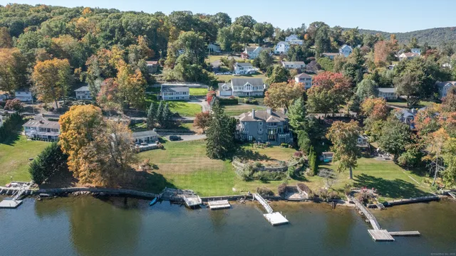 an aerial view of a houses with a lake view
