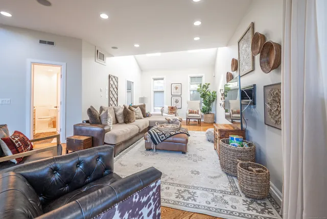a living room with fireplace furniture and a large window