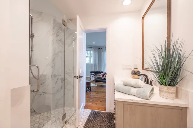 a living room with furniture and a floor to ceiling window