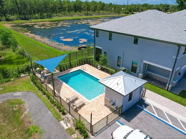 an aerial view of a house with a yard and lake view
