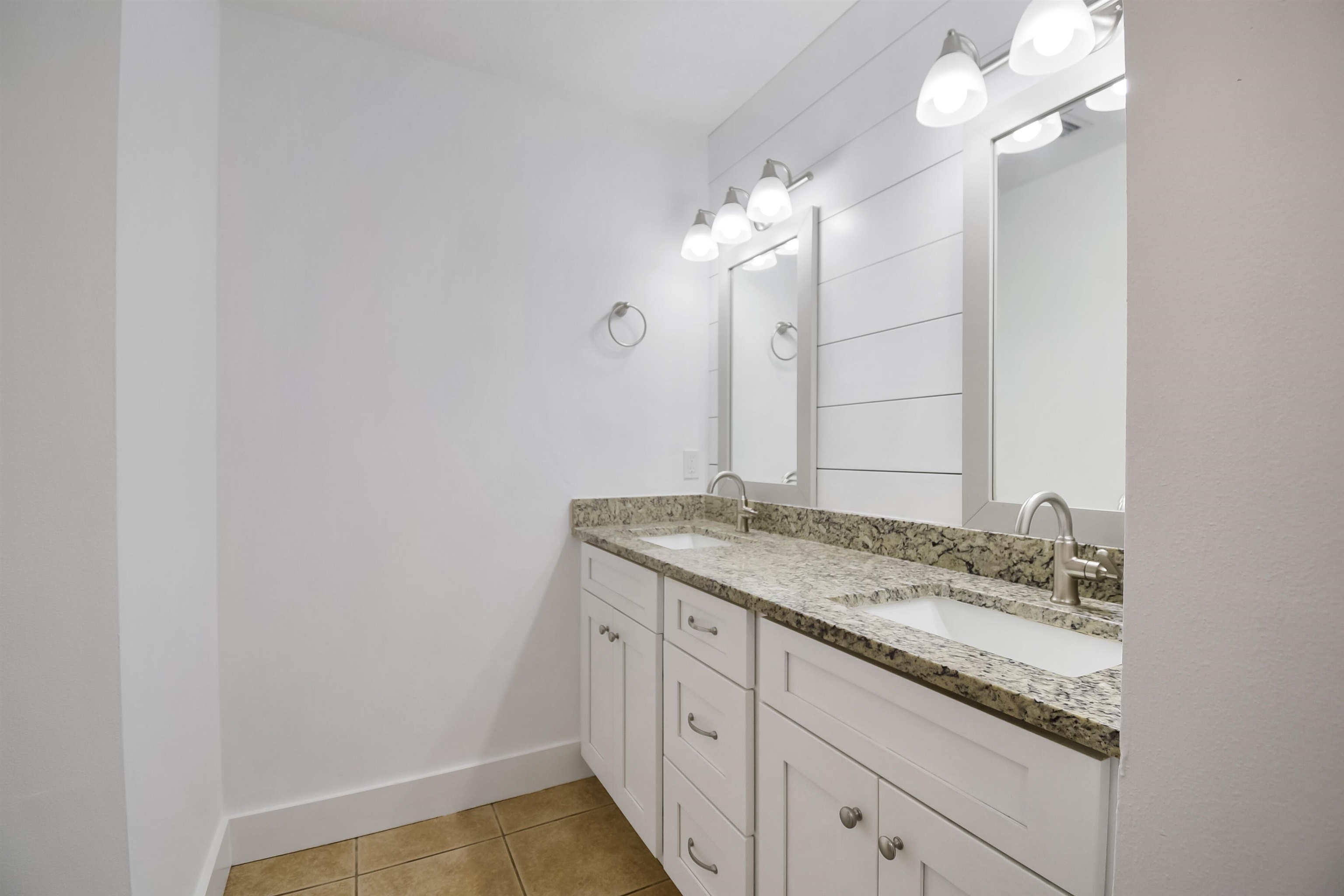 497 Pyrus Street St. Augustine, FL 32080 - Photo 16 of 36 a bathroom with a granite countertop sink and a mirror